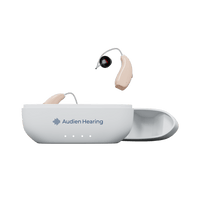 Audien Ion Pro hearing aids with one in charging case and one suspended above, front view